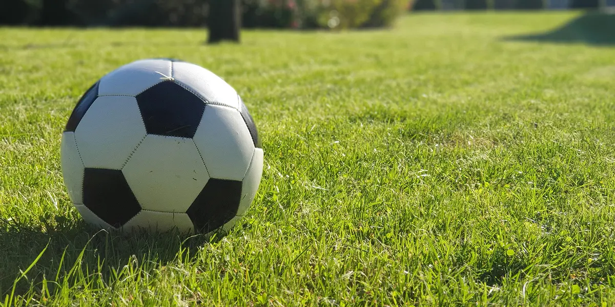 Soccer ball on a grass field representing GAMEC Youth sports programs
