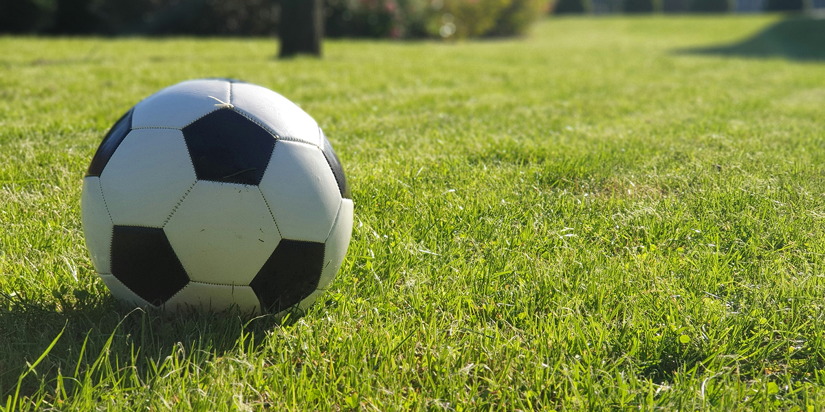 Soccer ball on a grass field representing GAMEC Youth sports programs